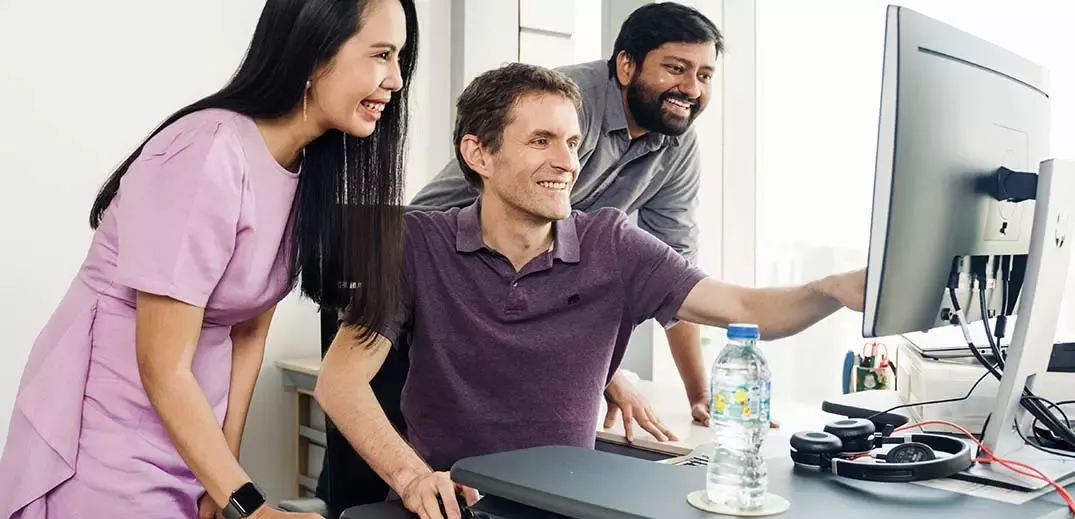 colleagues looking to a screen